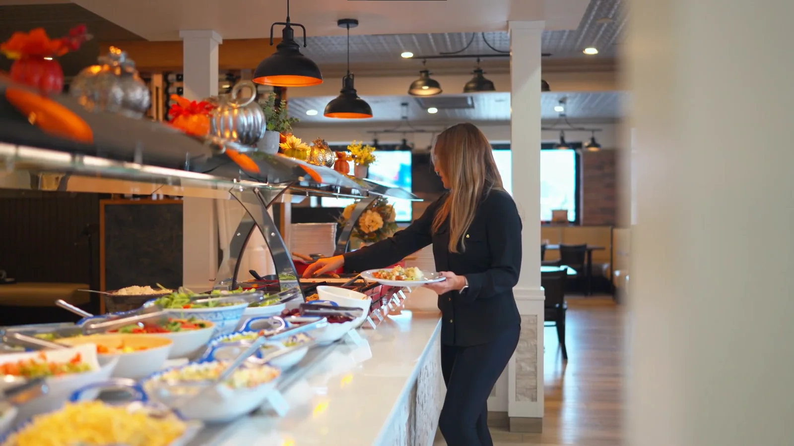 A guest choosing fresh food from the Brasa Brazilian buffet